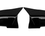Two glossy black car mirror covers lay side by side on a white background, facing each other symmetrically. They are smooth and have a sleek, aerodynamic design.