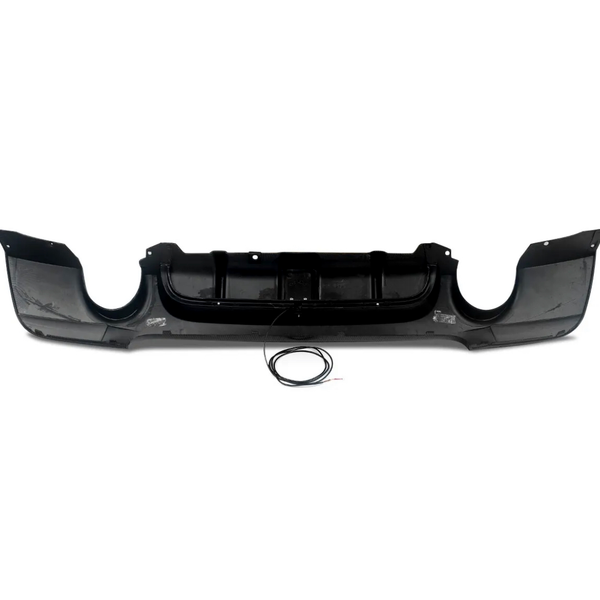 A black car bumper with an aggressive design is shown laying flat on a white background. A coiled wire is placed in front of it, implying potential attachment or installation.