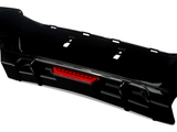 The object is a black car bumper with an integrated red reflector, resting on a white background. The design features cutouts for attachment, suitable for automotive enhancement.