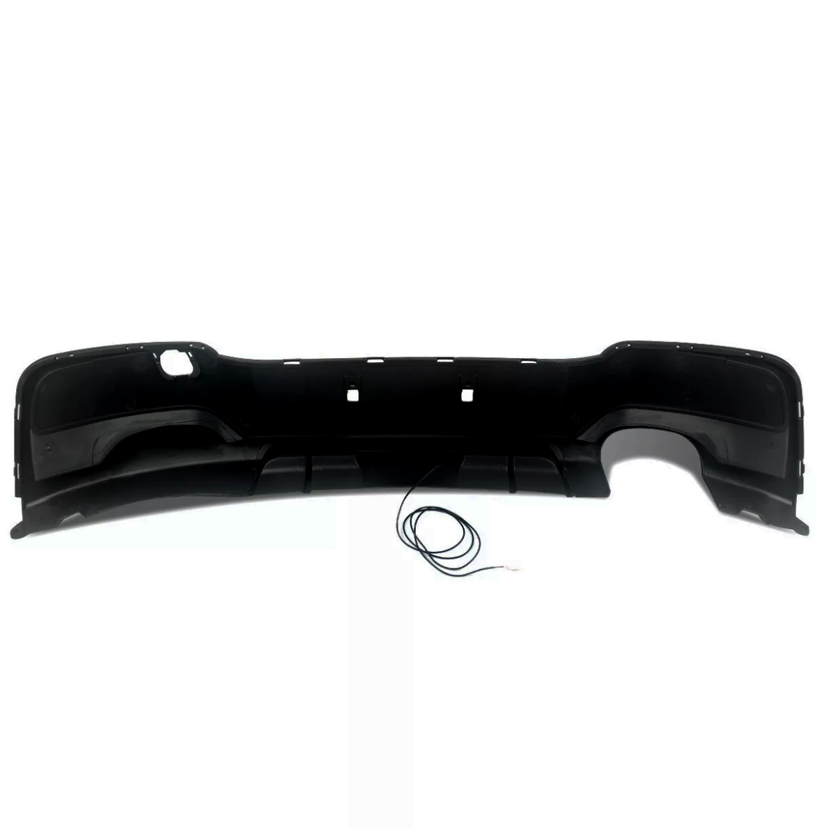 A black car bumper rests on a white background, featuring a curved shape with cutouts, and a thin cable lies coiled below it.