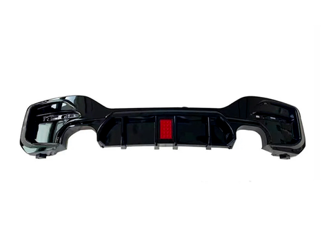 The black car bumper features a red reflector at its center, set in a plain white background, emphasizing its design details.