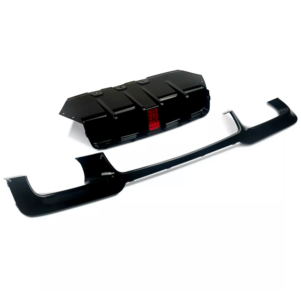 A black car bumper and diffuser with a red reflector displayed against a white background, highlighting their glossy surfaces and angular design.