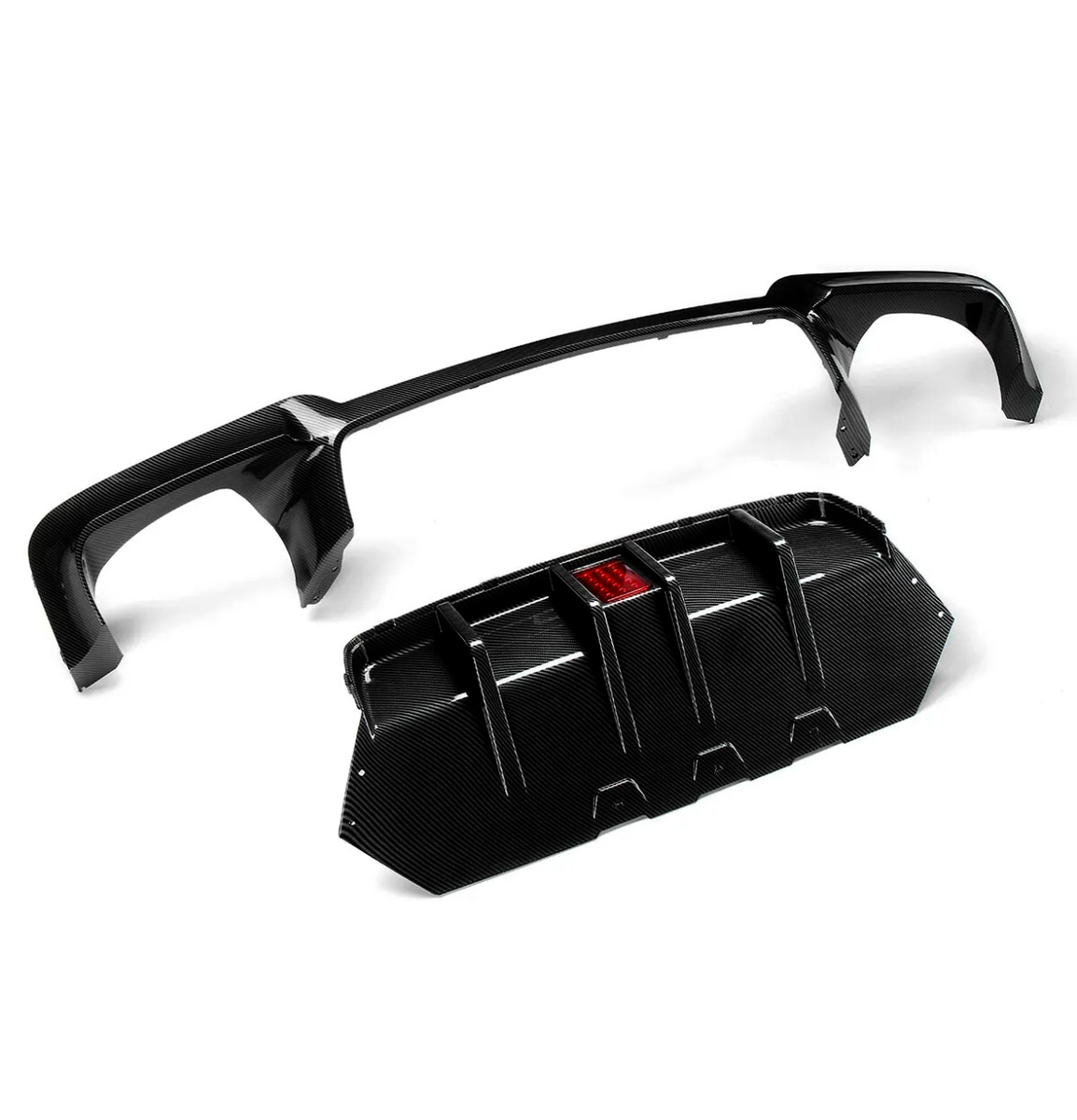 Carbon fiber car spoiler and diffuser resting separately, with the diffuser featuring a central red reflector; placed on a plain white background.