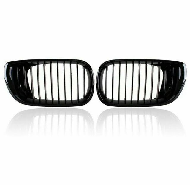 Two black car kidney grilles with vertical slats are shown against a plain white background, reflecting slightly underneath, suggesting a glossy surface.