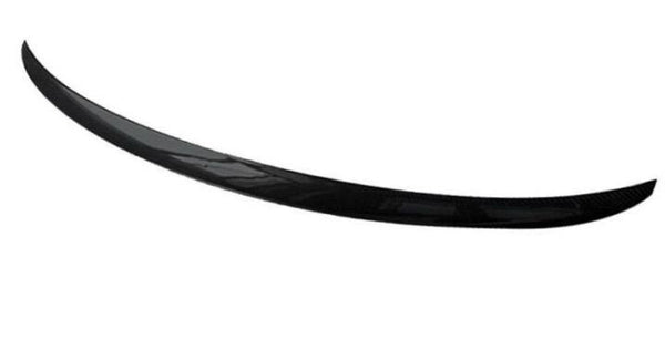 A sleek, black carbon fiber spoiler curves gracefully in a minimalist, white background.