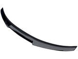 Curved black car spoiler resting on a plain white background, highlighting its aerodynamic design without visible attachments.