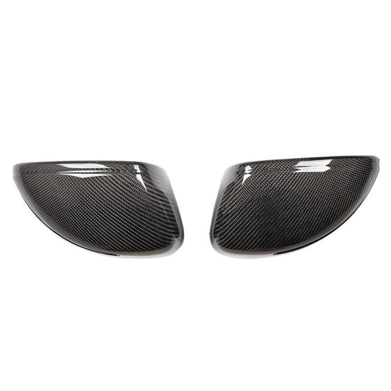 Two carbon fiber mirror covers are positioned side by side, displaying a smooth, reflective surface with a distinct woven pattern. The white background accentuates their sleek design.