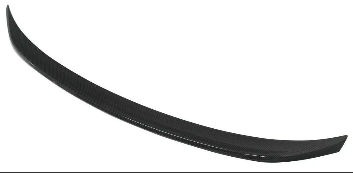 A black, curved car spoiler made of carbon fiber material is displayed against a plain white background.