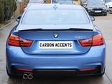 A blue BMW 420d is parked outdoors on a concrete surface, featuring dual exhausts and red taillights. The rear license plate reads 