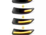Sequential images of a car turn signal light gradually increasing in illumination from dim to bright, within a streamlined black housing, depicted against a plain white background. Yellow arrows indicate progression.