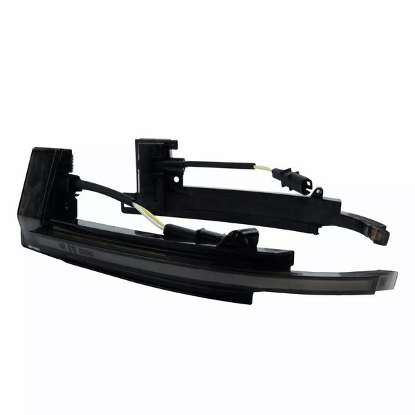 Black car side mirror indicator housing with attached wiring, shown in an isolated setting. The components are disassembled, allowing visibility of internal wires and connectors.