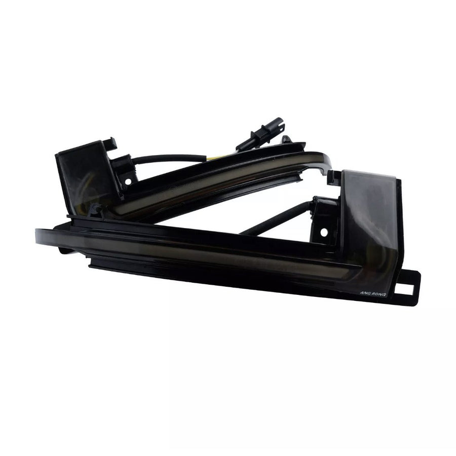 A sleek black automotive light fixture with wiring, labeled "AMG RGNG," against a white background, showcasing its angular design and curved edges.
