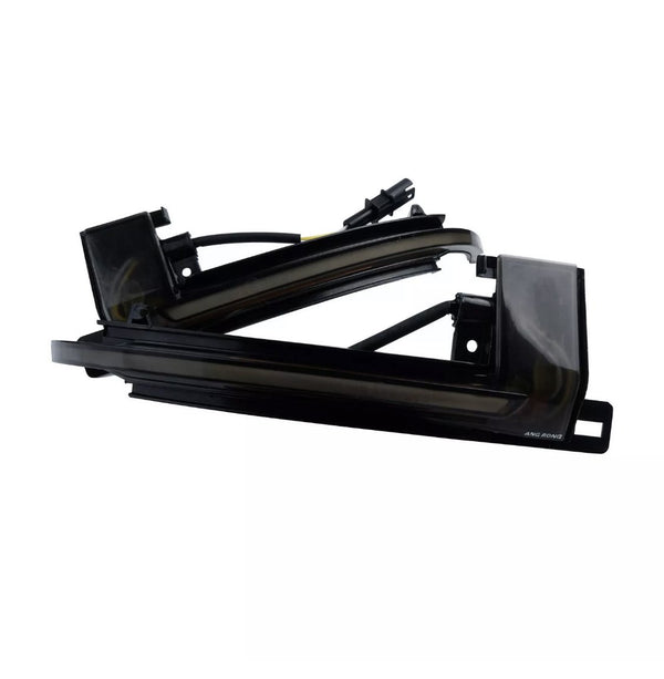 A sleek black automotive light fixture with wiring, labeled "AMG RGNG," against a white background, showcasing its angular design and curved edges.