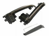 Two sleek, curved black car light covers with mounting brackets are placed on a white background. Below, a separate black trim piece and a small metal tool are included.