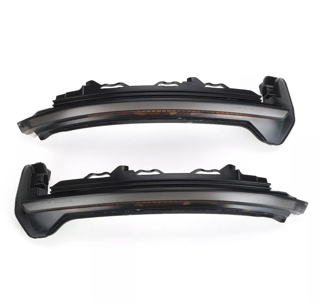 Two dark, sleek car LED rearview mirror indicators are parallel, displaying a modern design. The context is a plain white background, highlighting the components' structure.