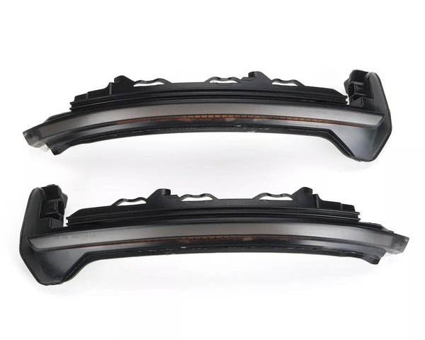 Two dark, sleek car LED rearview mirror indicators are parallel, displaying a modern design. The context is a plain white background, highlighting the components' structure.