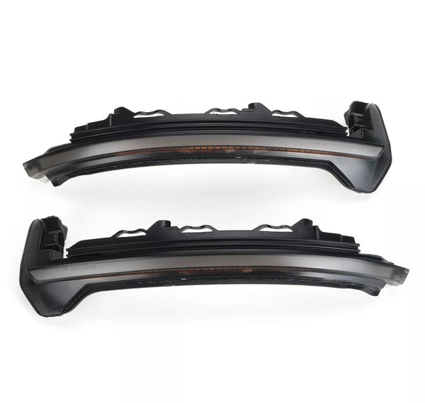 Two dark, sleek car LED rearview mirror indicators are parallel, displaying a modern design. The context is a plain white background, highlighting the components' structure.