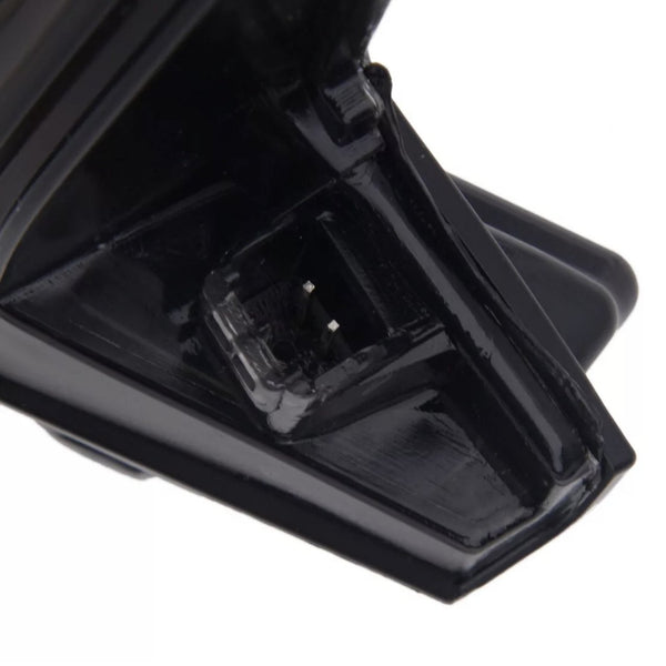 A black, plastic connector with silver prongs is displayed in close-up, set against a plain background, showing intricate design details.