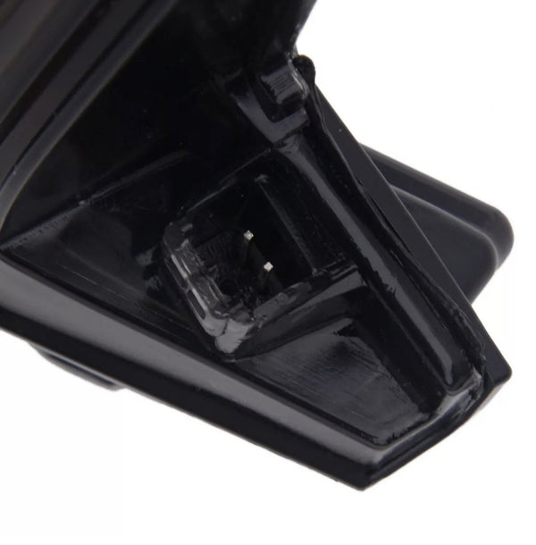A black, plastic connector with silver prongs is displayed in close-up, set against a plain background, showing intricate design details.