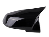 A black, aerodynamic side mirror cover is shown against a plain white background, highlighting its smooth, glossy finish and sleek design.