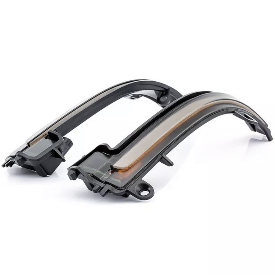 Two black, curved LED turn signal lights for a vehicle, resting side-by-side on a plain white background, with a sleek design and translucent covering.