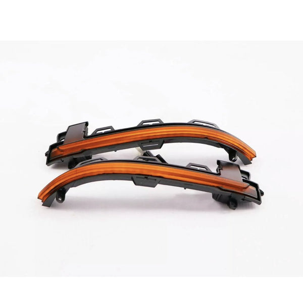 Curved LED light strips are positioned against a plain white background. The strips are embedded in black plastic casings, designed to be mounted, likely for automotive use.