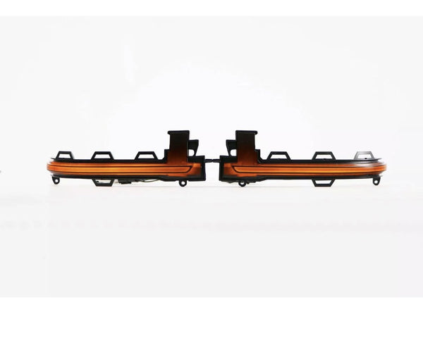 Two orange and black car light strips are positioned with a connecting joint between them. They are set against a plain white background, emphasizing their symmetrical design.