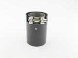 A cylindrical, carbon-fiber exhaust tip with a metal clamp sits on a plain white background, showcasing its sleek, industrial design.