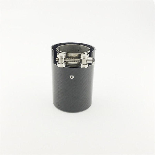 A cylindrical carbon fiber exhaust tip with a metal clamp is centered on a plain white background. The tip features a sleek design, enhancing vehicle exhaust systems.