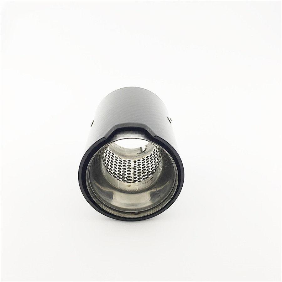 A black cylindrical exhaust tip, featuring a metallic interior with perforated detailing, is positioned upright in a minimalist, white background setting.