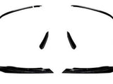 Black, glossy car spoilers and side skirts are arranged symmetrically on a white background, suggesting their use for a vehicle's aerodynamic enhancement.