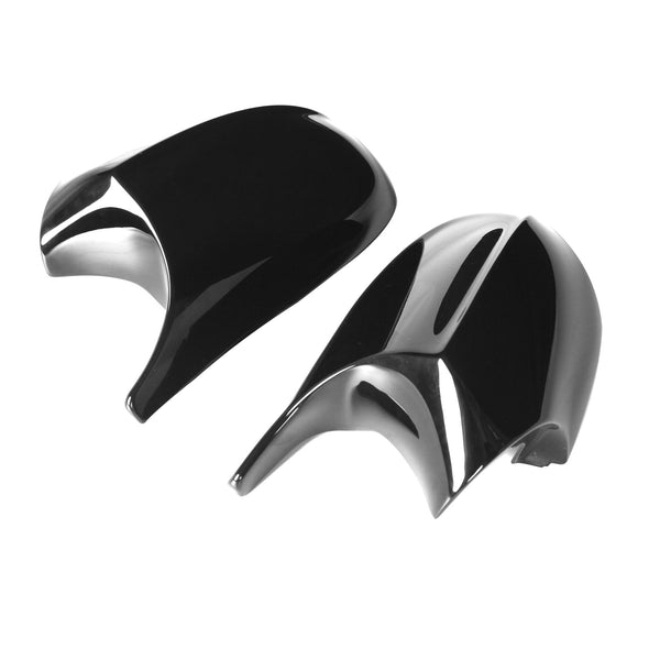 Two black, glossy car mirror covers, lying side by side, are positioned on a plain white background.