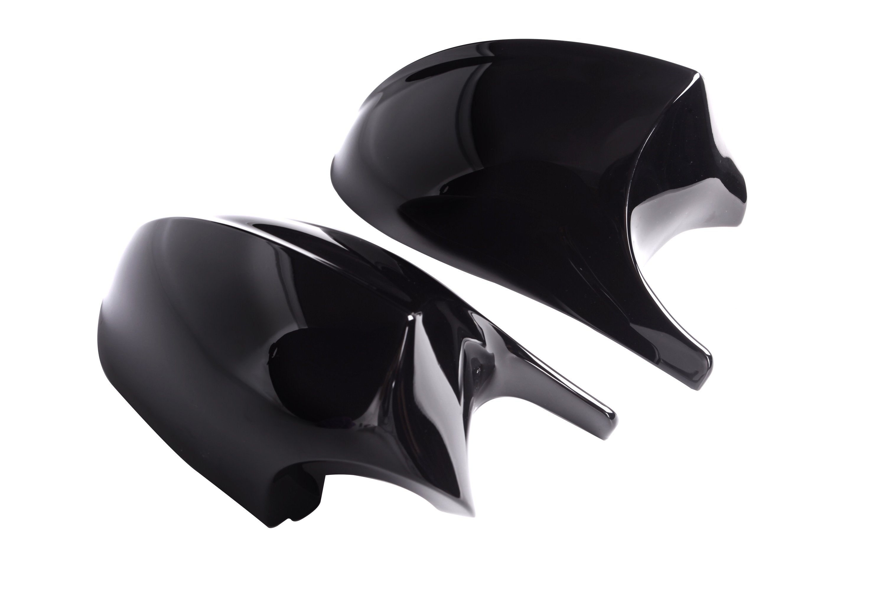 Two shiny black car mirror covers rest side by side against a plain white background, reflecting light on their smooth surfaces.
