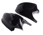 Two shiny black car mirror covers rest side by side against a plain white background, reflecting light on their smooth surfaces.