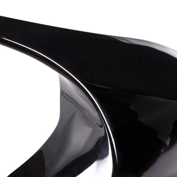 A sleek, shiny black stiletto heel with a pointed tip stands isolated against a plain white background.
