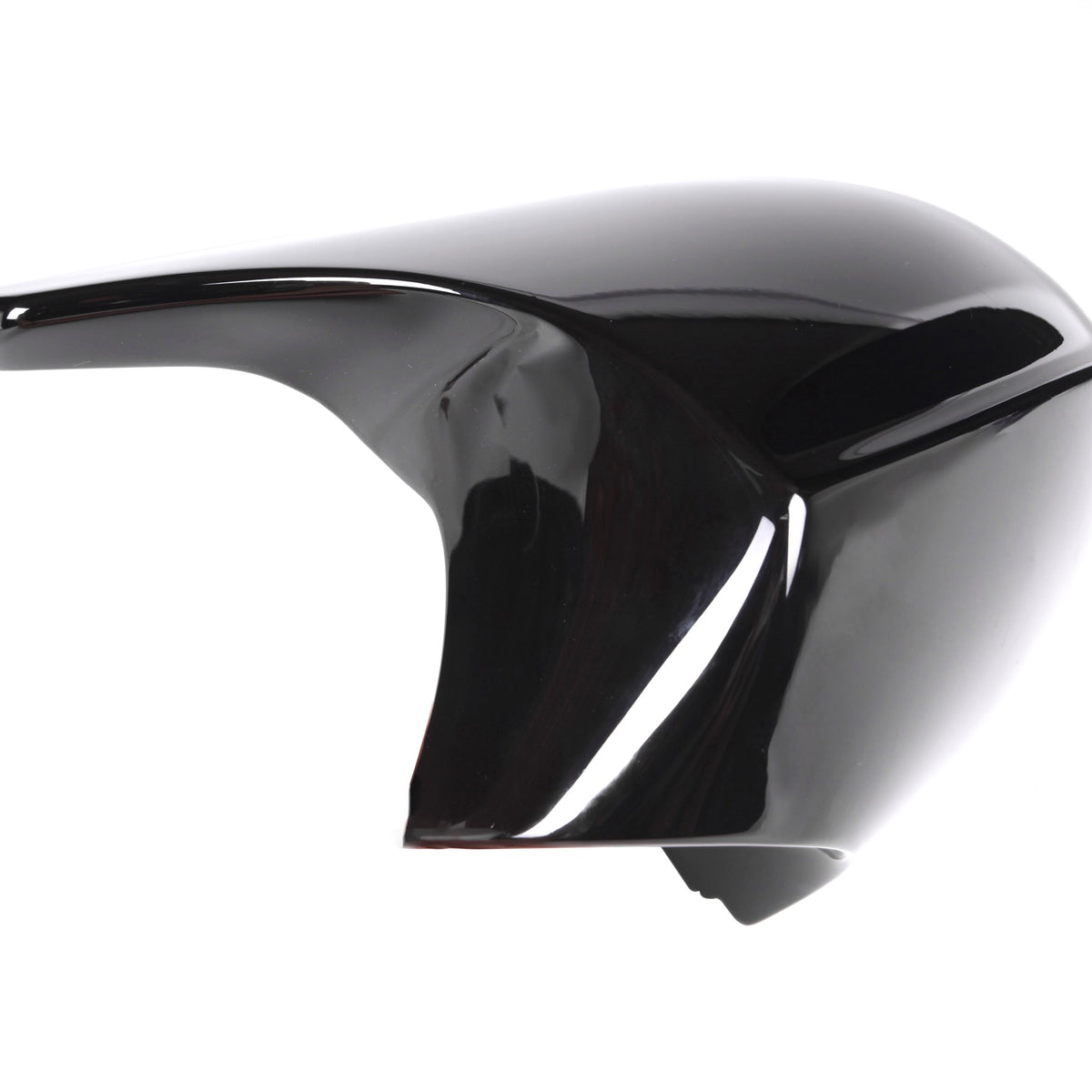 A glossy black motorcycle fairing sits on a white background, showcasing its smooth, aerodynamic curves and reflective surface.