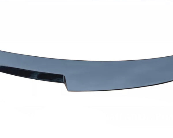 A glossy, curved black car spoiler, smoothly finishes in pointed edges, placed against a white background.