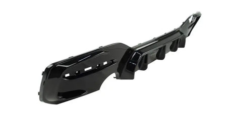 A glossy black car bumper with vent openings lies on a plain white background, displaying an angular, aerodynamic design.