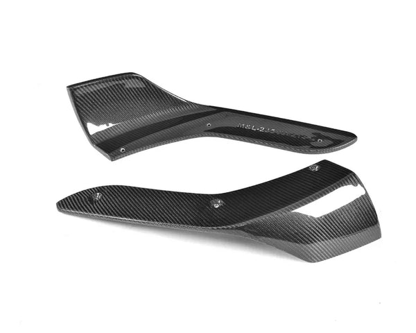 Two black carbon fiber automotive parts are placed on a white background. Text on one part reads "M&L-235-V1R7-2". Both parts have a sleek, aerodynamic design with mounting holes.