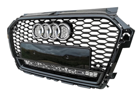 A black car grille with a honeycomb pattern, featuring four chrome rings and "quattro" text, is displayed against a plain background.
