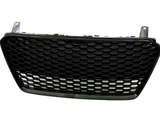 The object is a black, hexagonal-patterned car grille, resting upright against a plain white background, designed for ventilation and protection in automotive use.