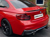 A red BMW car parked on a street, displaying the license plate 
