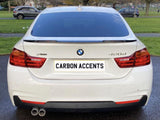 A white BMW 420d is parked on a paved path, with 