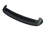 A curved carbon fiber car spoiler rests against a white background. It is glossy and designed to enhance aerodynamic performance.